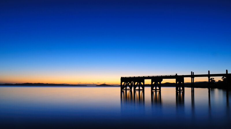 Silhouette of a pier at dusk
