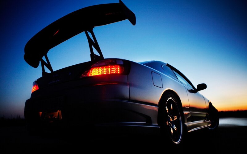 Silhouette of a sports car at dusk