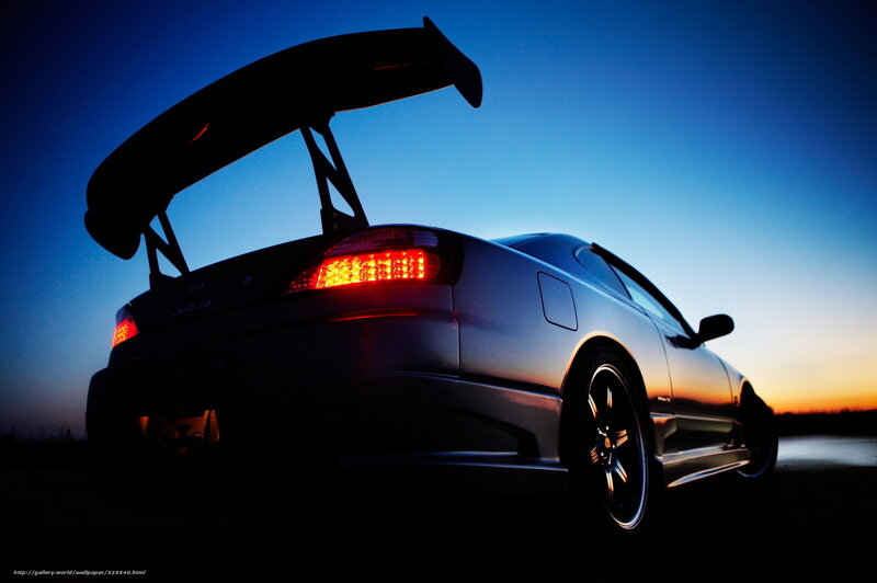 Silhouette of a sports car at dusk