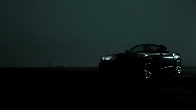 Silhouette of a sports car at night