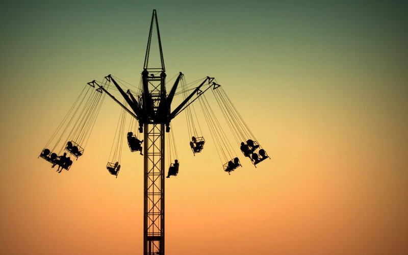 Silhouette of a swing ride at sunset