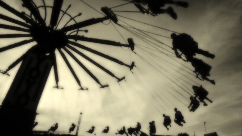 Silhouette of a swinging ride