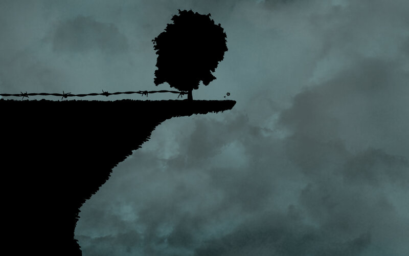 Silhouette of a tree on a cliff