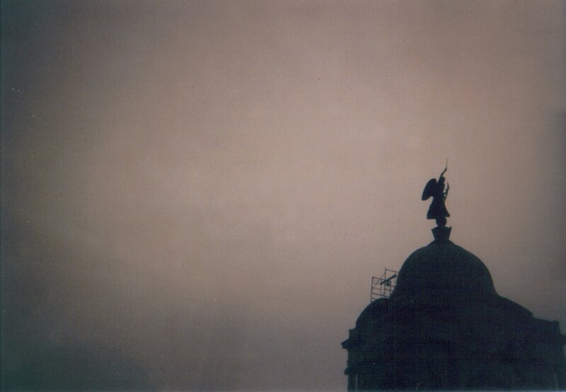silhouette of angel statue on dome