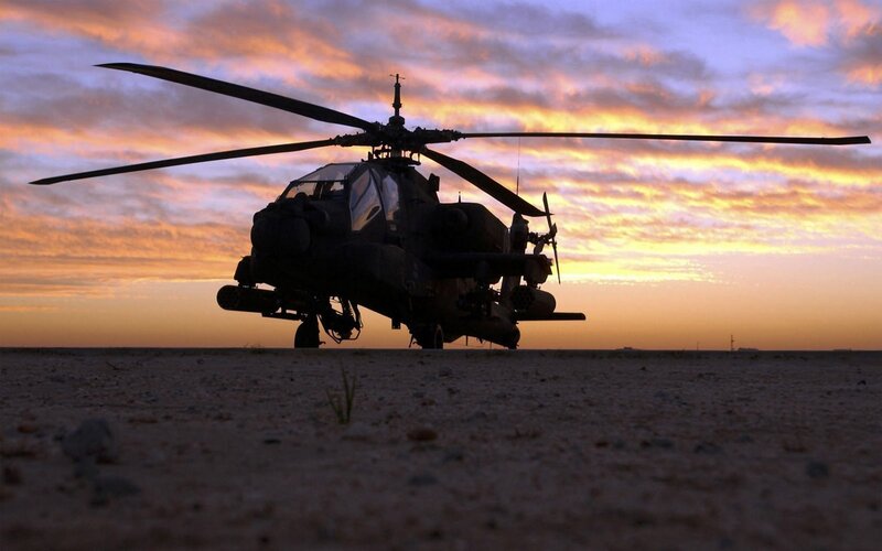 Silhouette of attack helicopter at sunset