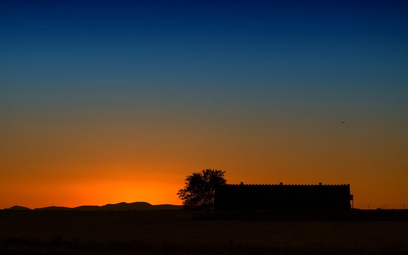 Silhouette of Barn and Tree