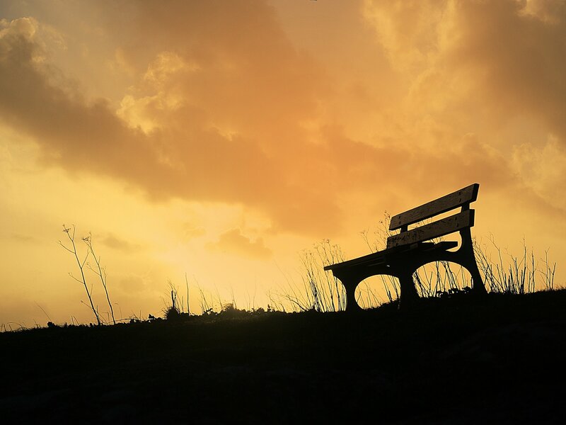 Silhouette of bench at sunset