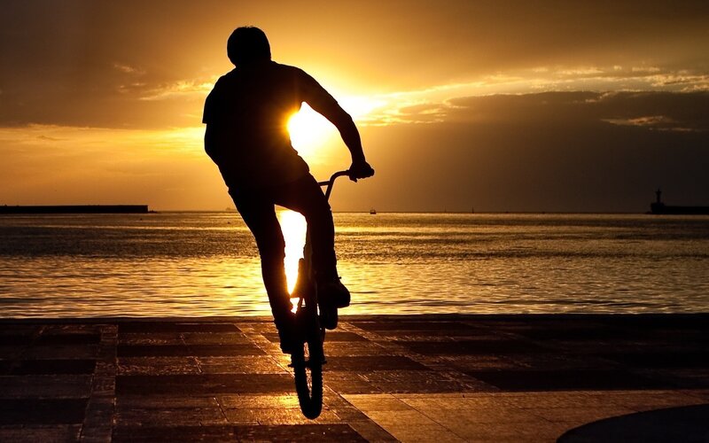 Silhouette of biker at sunset