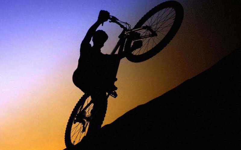 silhouette of biker at sunset