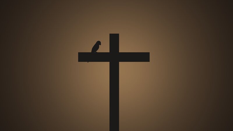 silhouette of bird on cross
