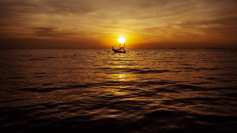 Silhouette of Boat at Sunset — Orange, Serene, Photograph