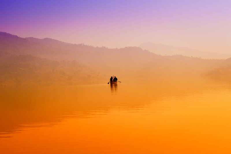 Silhouette of boat on calm lake