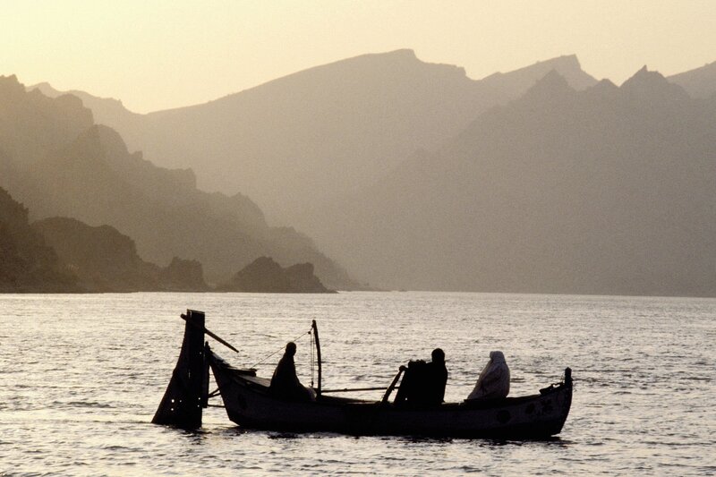 Silhouette of boat on calm water