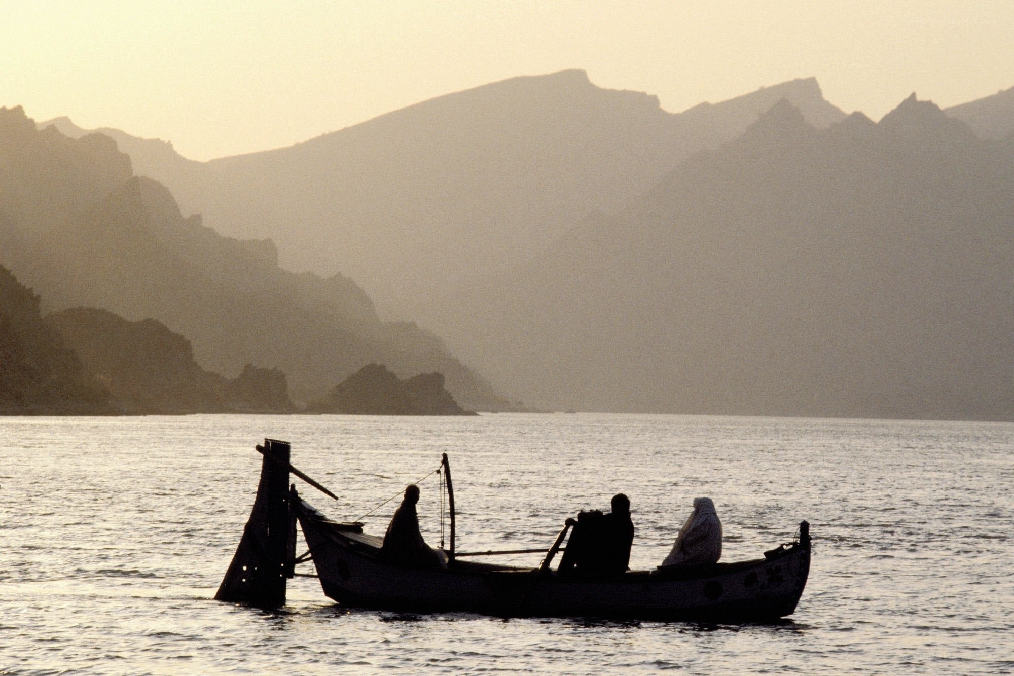 Silhouette of boat on calm water