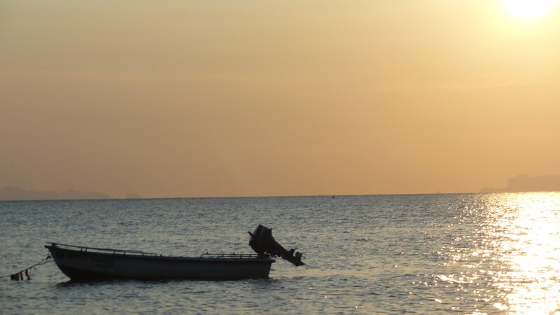 Silhouette of Boat on Water — Orange, Serene, Sunset, Photograph, Motor