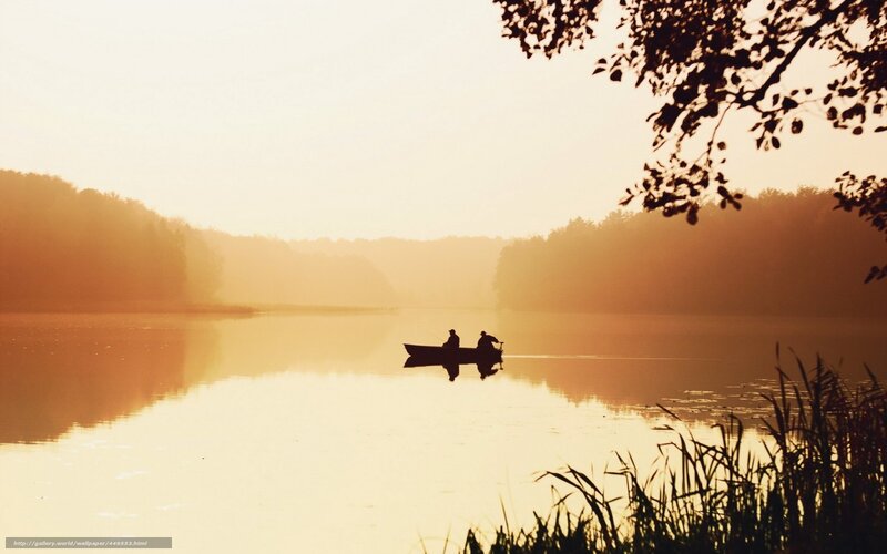Silhouette of boaters on a lake