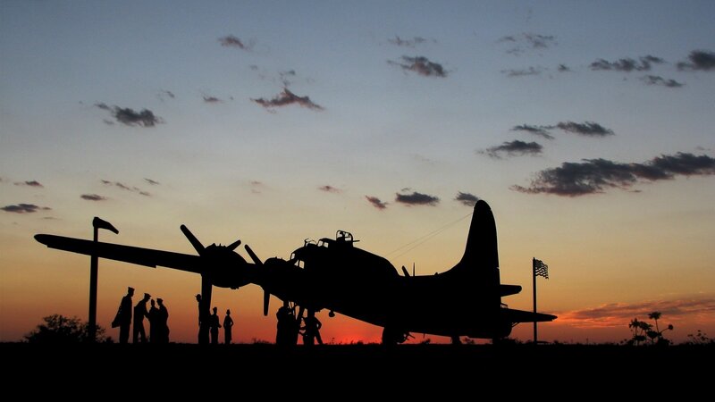 silhouette of bomber plane at sunset