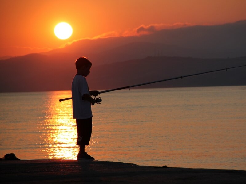 Silhouette of Boy Fishing