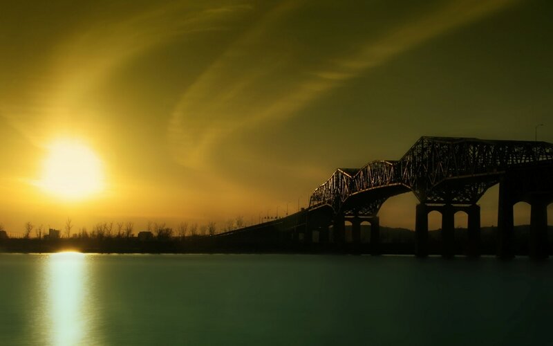 Silhouette of Bridge at Sunset — Yellow, Dramatic, Photograph, Sun, River, Trees, Green