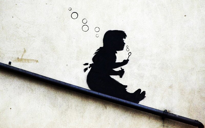 Silhouette of Child Blowing Bubbles