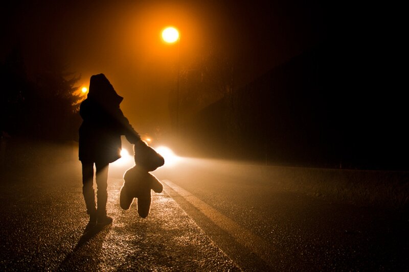 Silhouette of Child Holding Teddy Bear