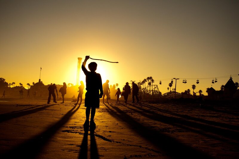 Silhouette of child on beach at sunset