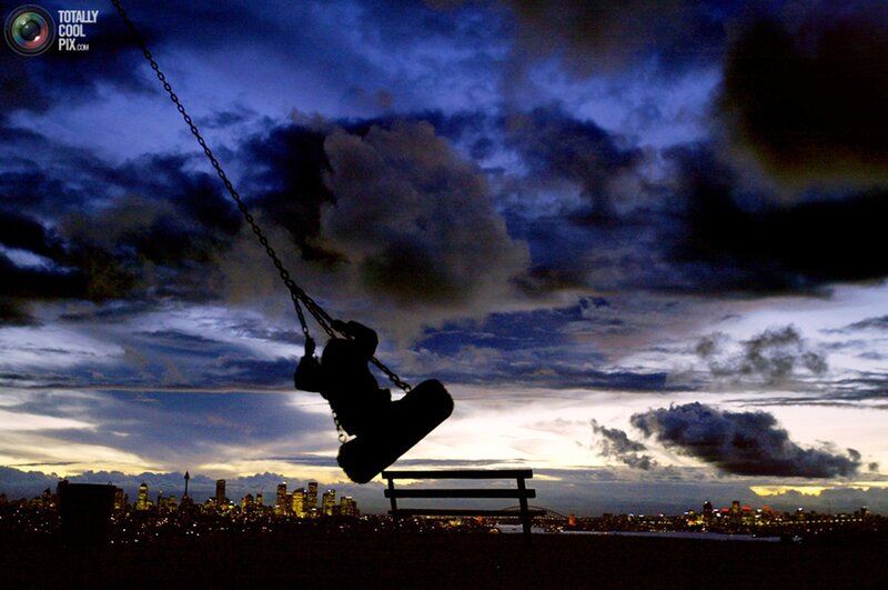 Silhouette of Child on Swing — Blue, Dramatic