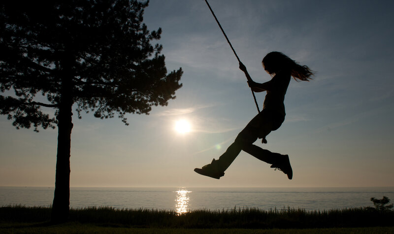 Silhouette of child on swing
