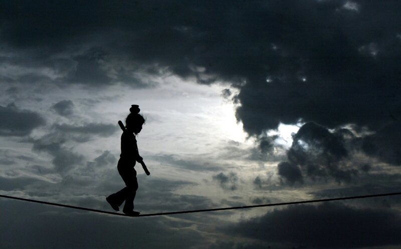 Silhouette of child on tightrope