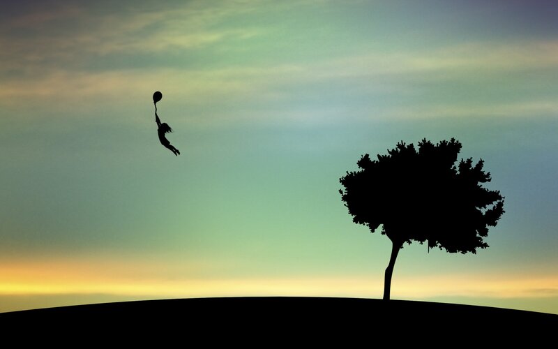 Silhouette of child with balloon