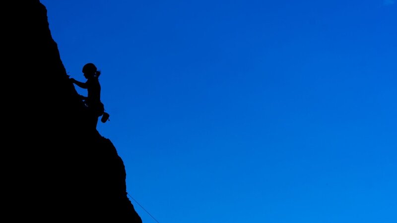 Silhouette of climber on rock