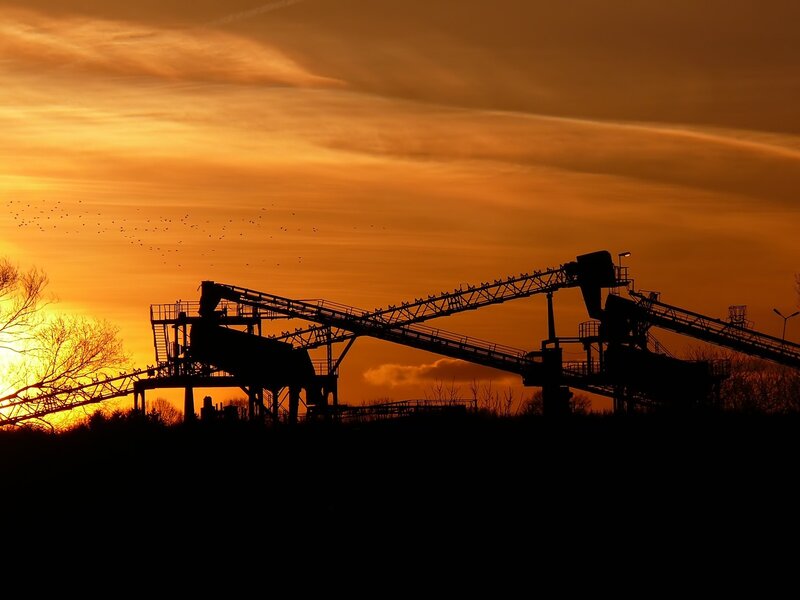 silhouette of conveyor belts at sunset