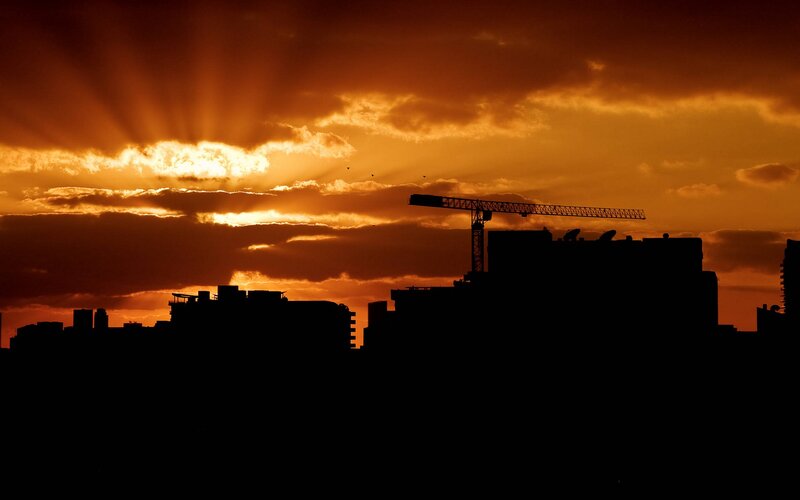 Silhouette of Crane and Buildings