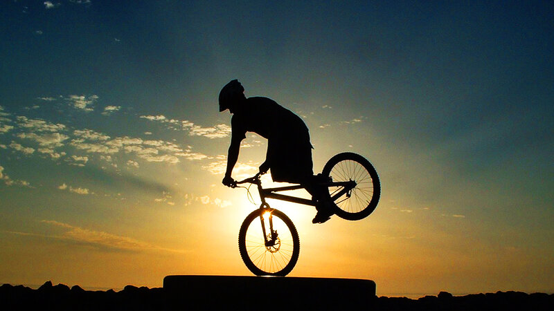 Silhouette of cyclist at sunset