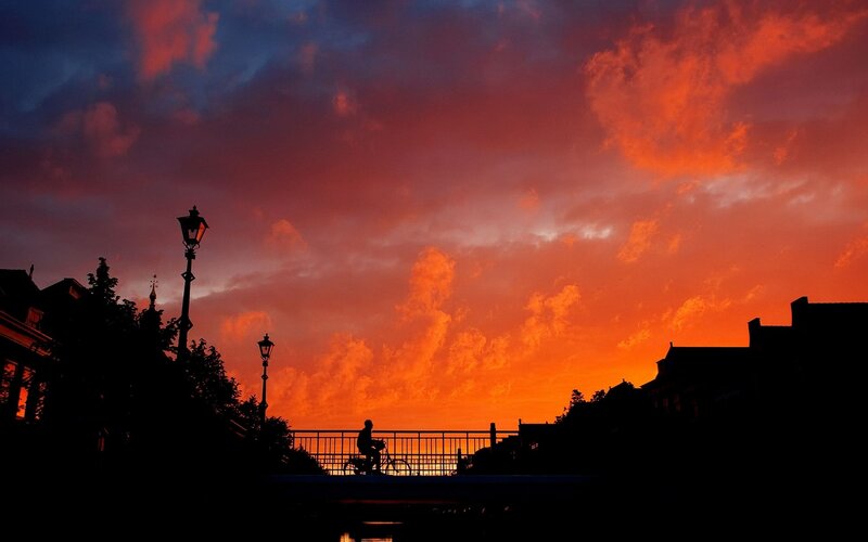Silhouette of cyclist at sunset