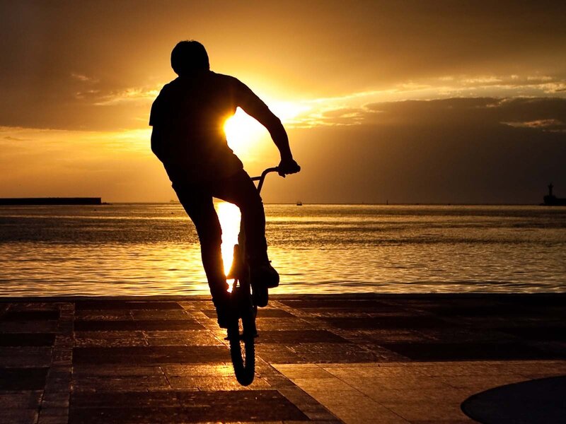 Silhouette of cyclist at sunset