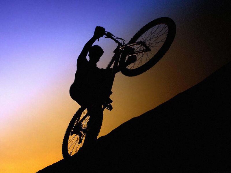 silhouette of cyclist at sunset