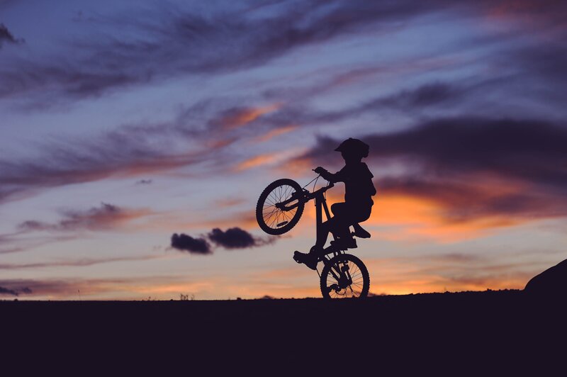 Silhouette of cyclist at sunset