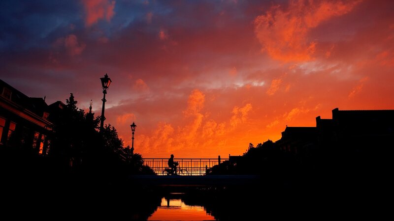 Silhouette of Cyclist on Bridge — Orange, Dramatic