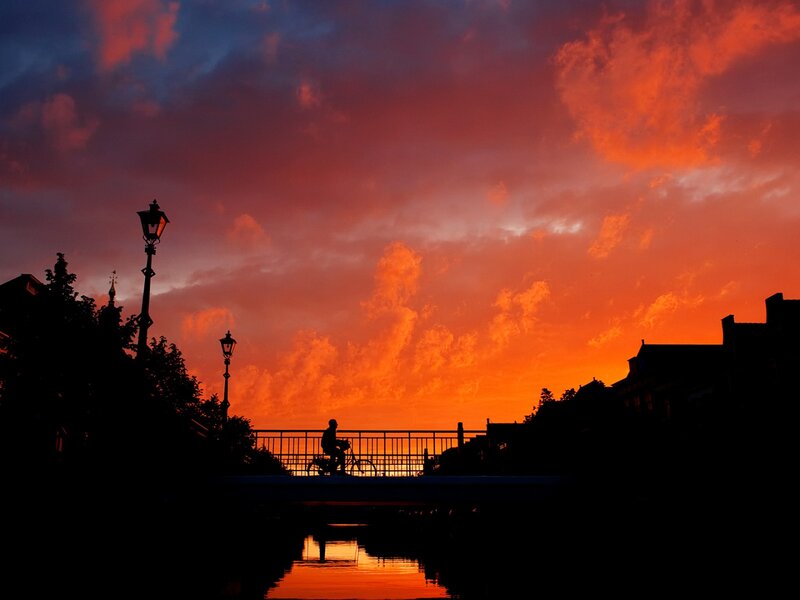Silhouette of Cyclist on Bridge — Orange