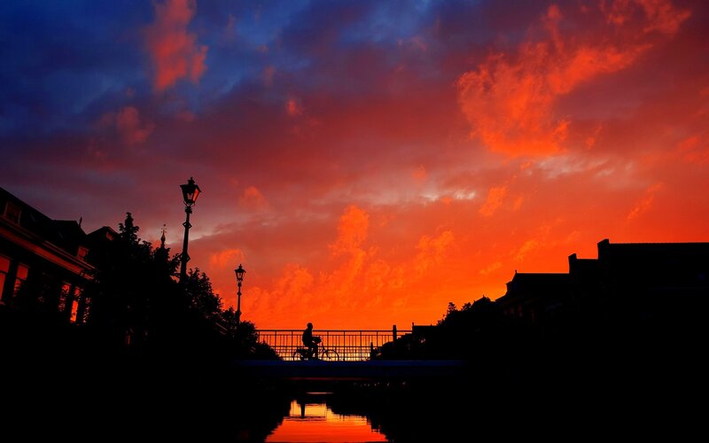 Silhouette of Cyclist on Bridge