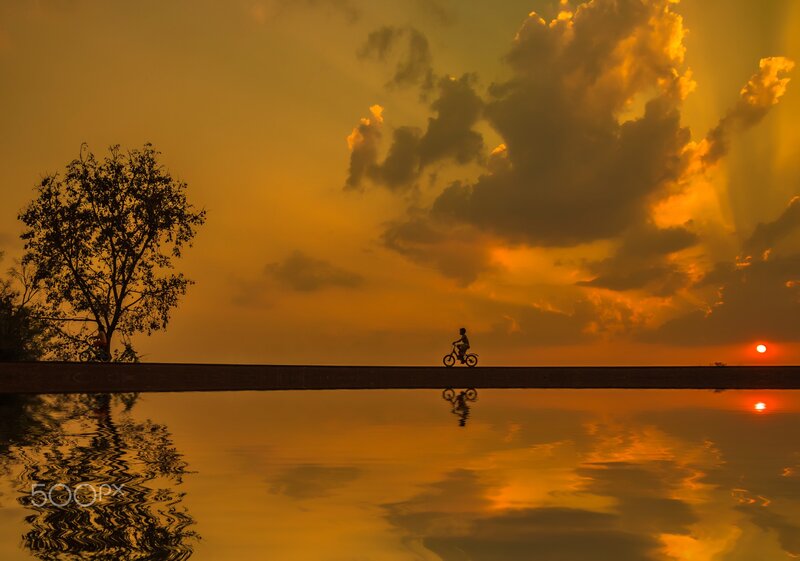 Silhouette of Cyclist — Orange, Serene