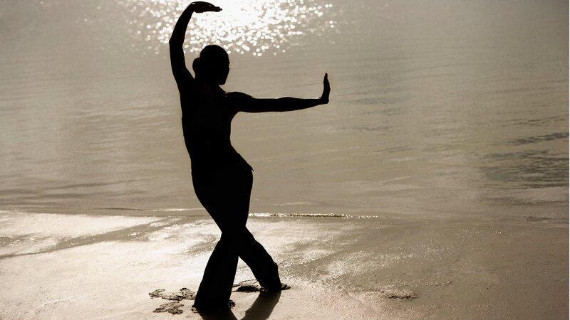Silhouette of dancer on beach