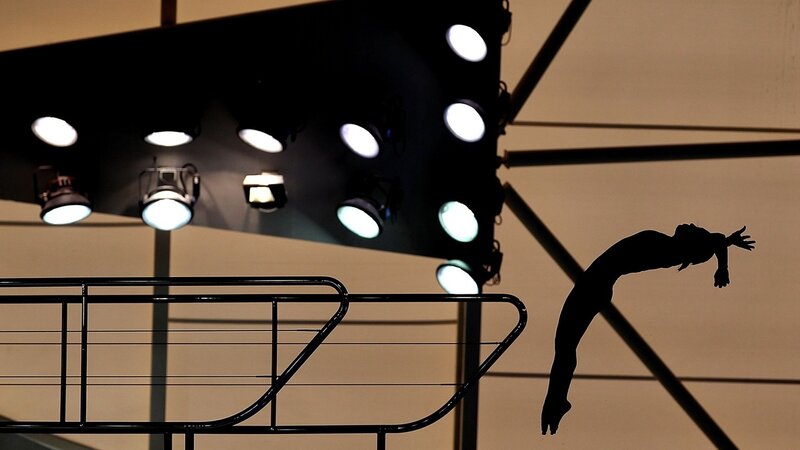 Silhouette of diver in mid-air