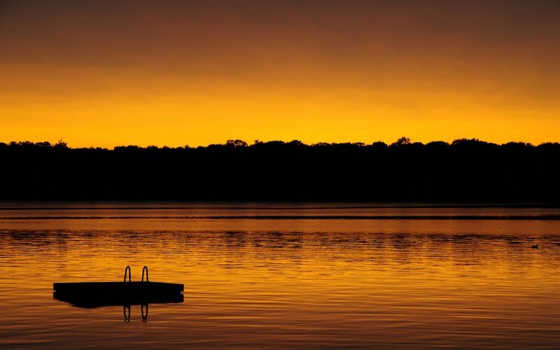 Silhouette of Dock on Lake