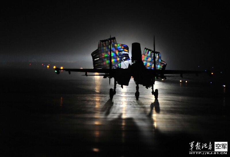 Silhouette of fighter jet at night