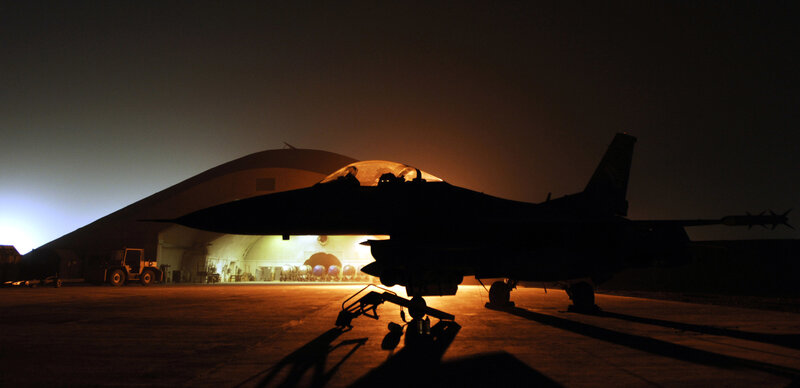 Silhouette of fighter jet at night