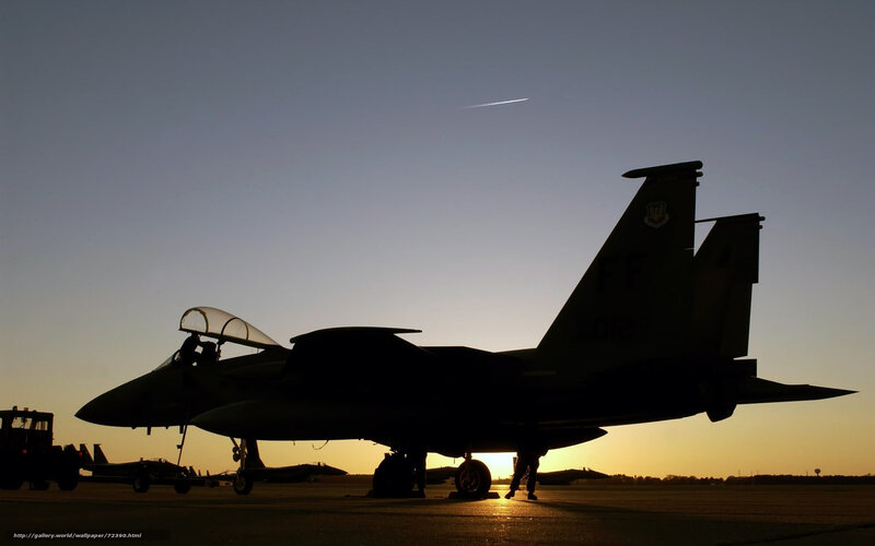 silhouette of fighter jet at sunset