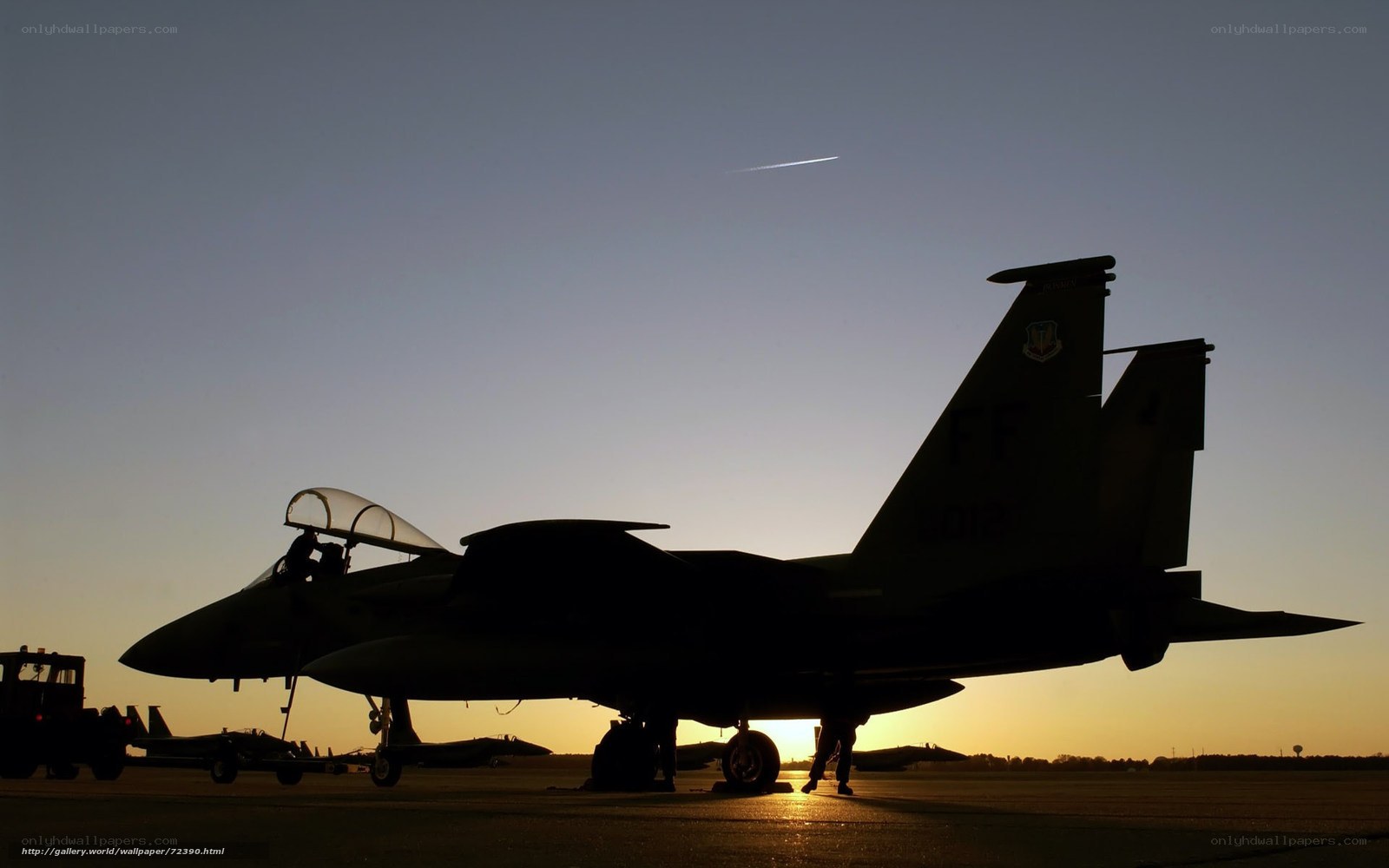 silhouette of fighter jet at sunset
