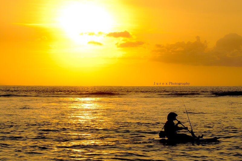 Silhouette of fisherman at sunset